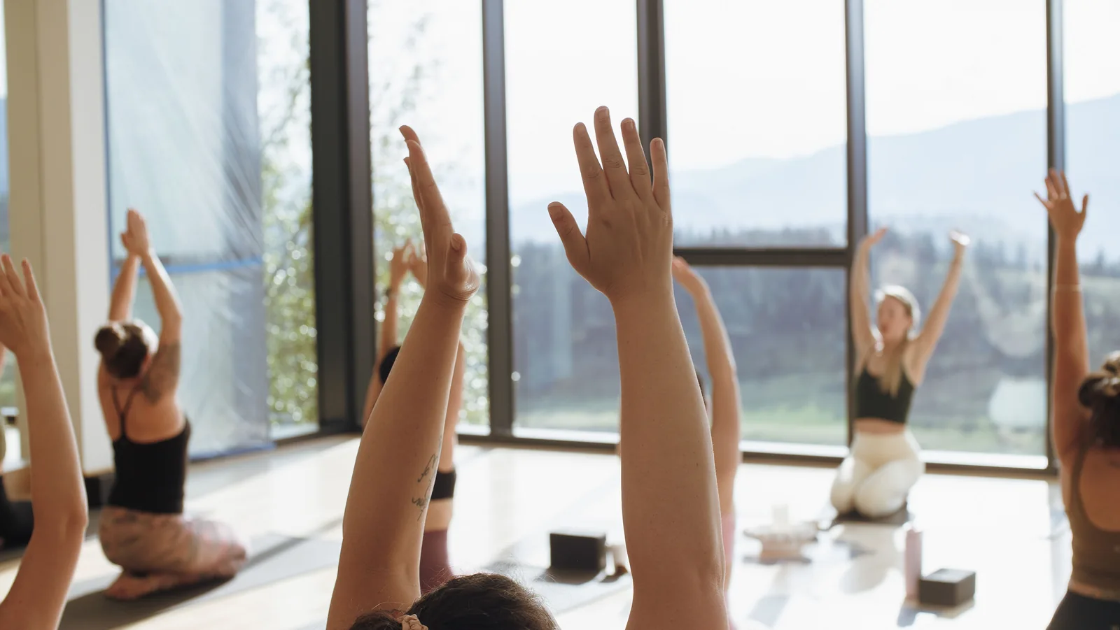 Guests reaching their arms upward during yoga at the Spring Reset retreat
