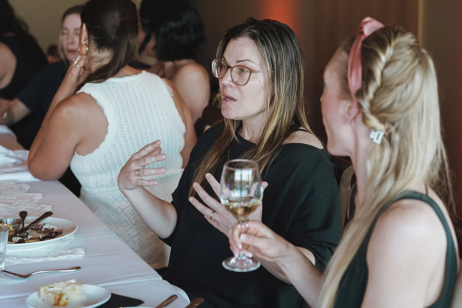 Guests talking together around a long dining table